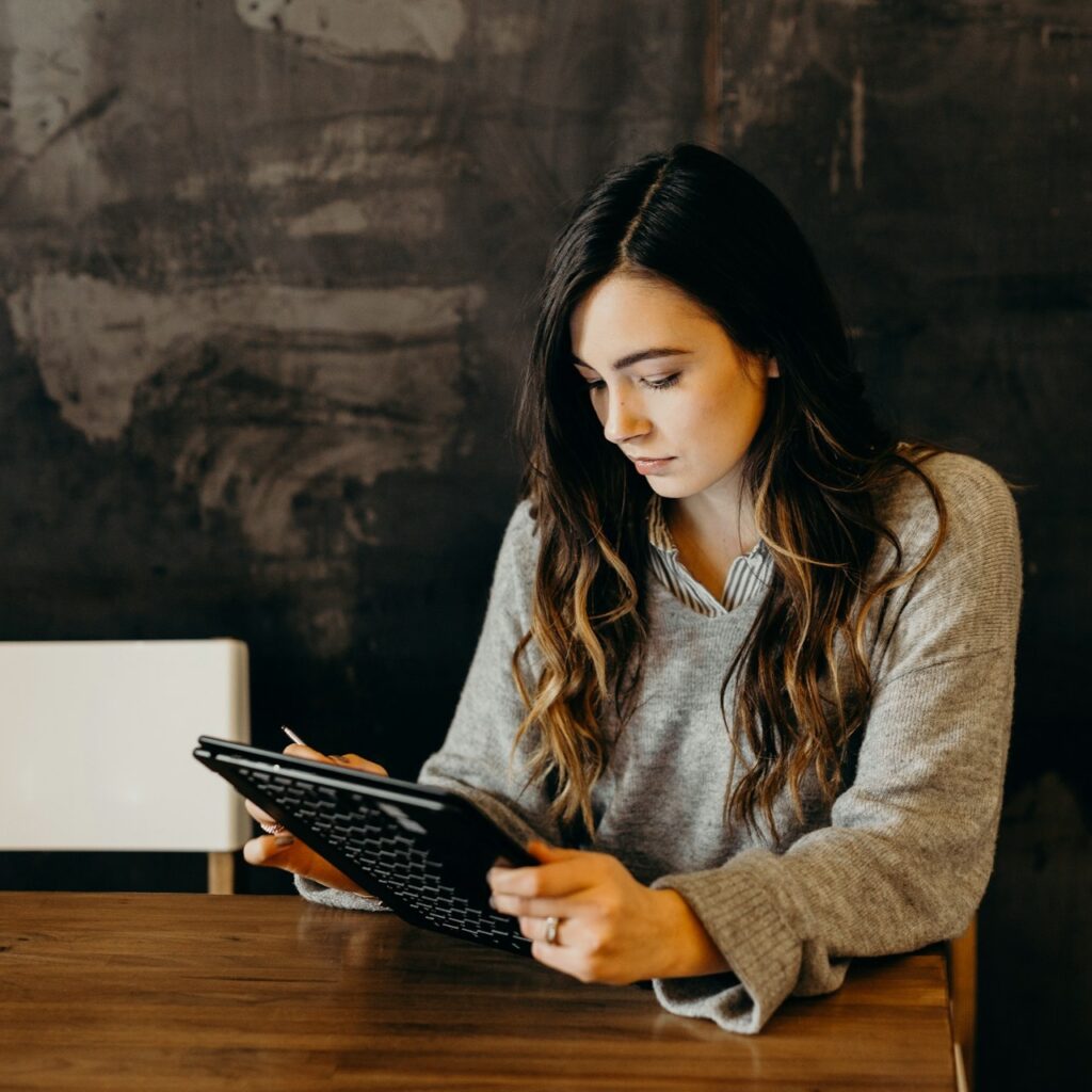 Student girl at caffe rading tablet